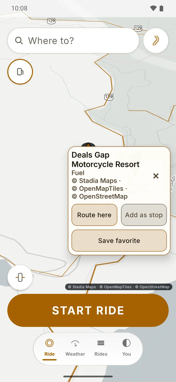 RIDE map on a twisty road with the twisty-roads overlay and a place card for a fuel stop offering Route here, Add as stop and Save favorite.