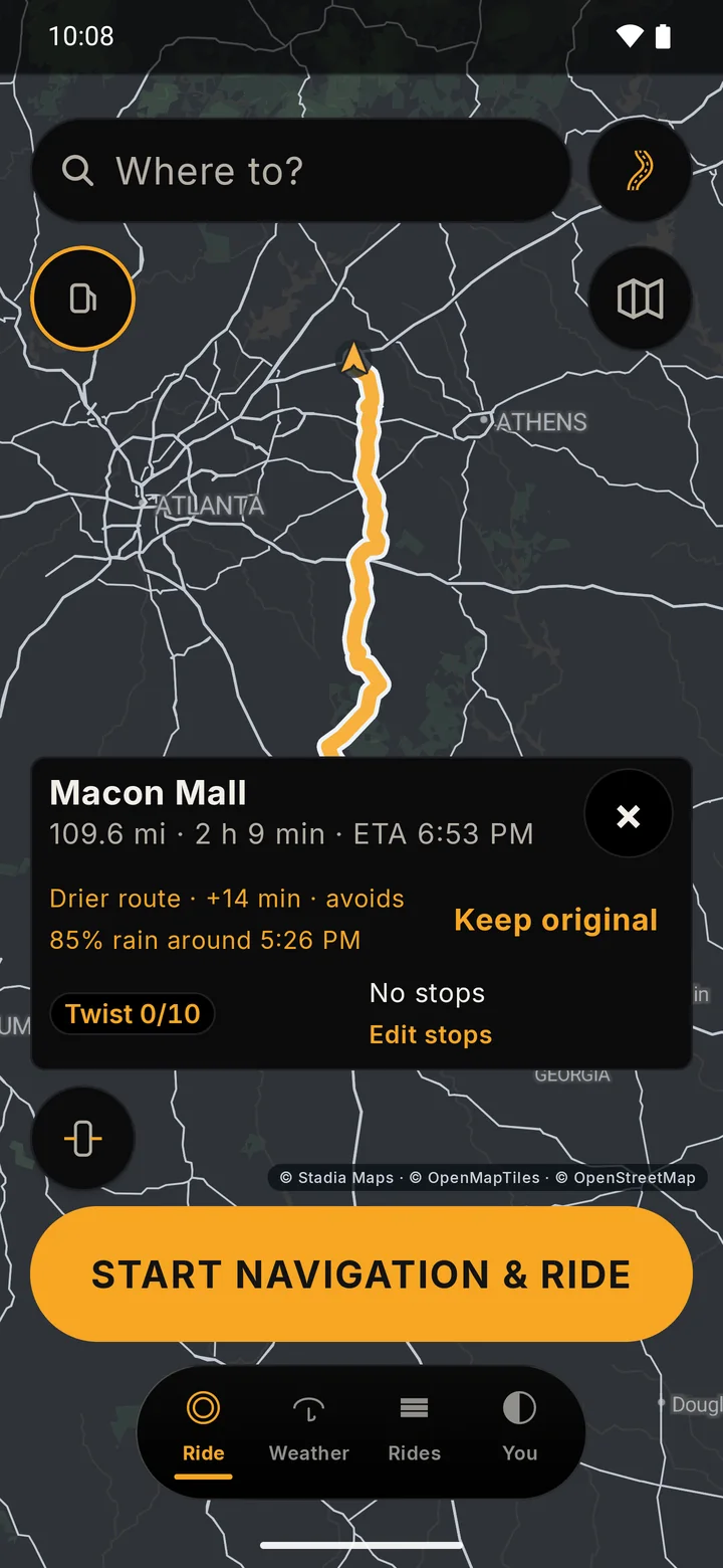 RIDE route card on a dark map for a long route, with an amber line reading Drier route, plus 14 minutes, avoids 85 percent rain, and a Keep original button beside it. The rain is simulated in a test build.
