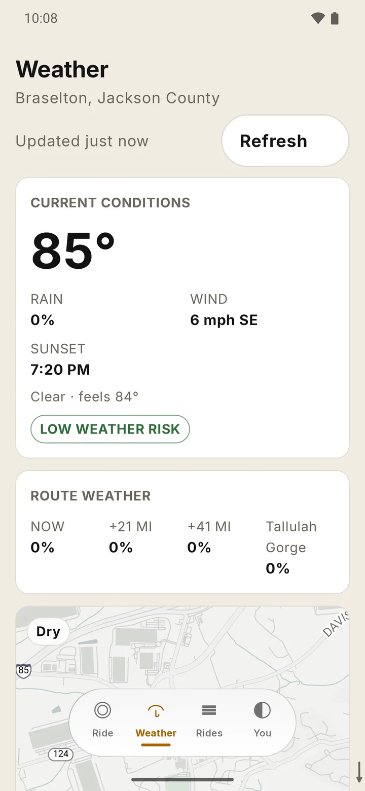 RIDE Weather tab: the current temperature and conditions with rain, wind and sunset, a Low weather risk chip, and a route weather block with rain chance at points ahead.